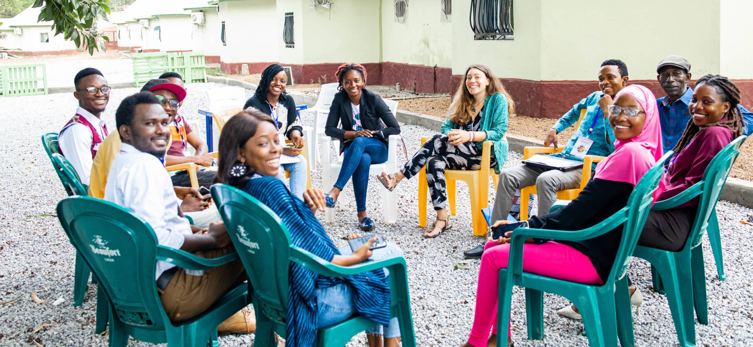 Youth activists from the Mano River region sit for a discussion outside.