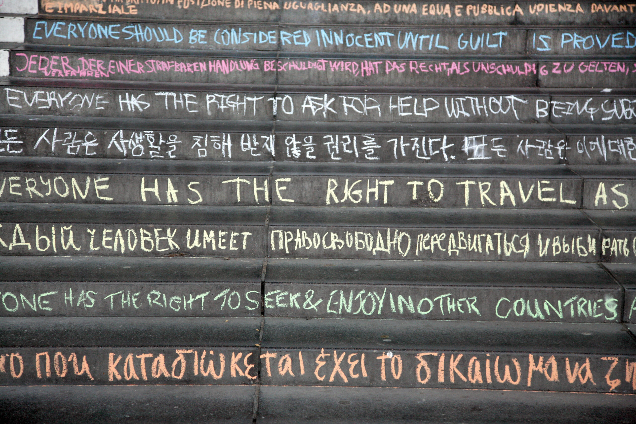 Students at the University of Essex write the articles of the Universal Declaration of Human Rights (UDHR) on the iconic concrete squares of the Colchester Campus.
