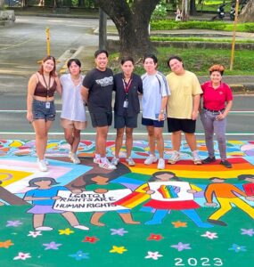 SOGIE mural cropped A group of student LGBTQ+ rights activists in the Philippines standing on a mural about the SOGIE Equality Bill.