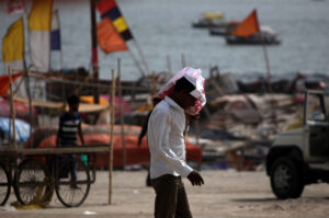 People walk during heat-wave conditions at the bank of the Ganges River in Prayagraj, India.